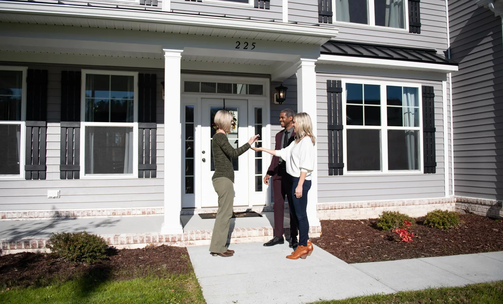 Image of a happy couple receiving the keys to their custom built home